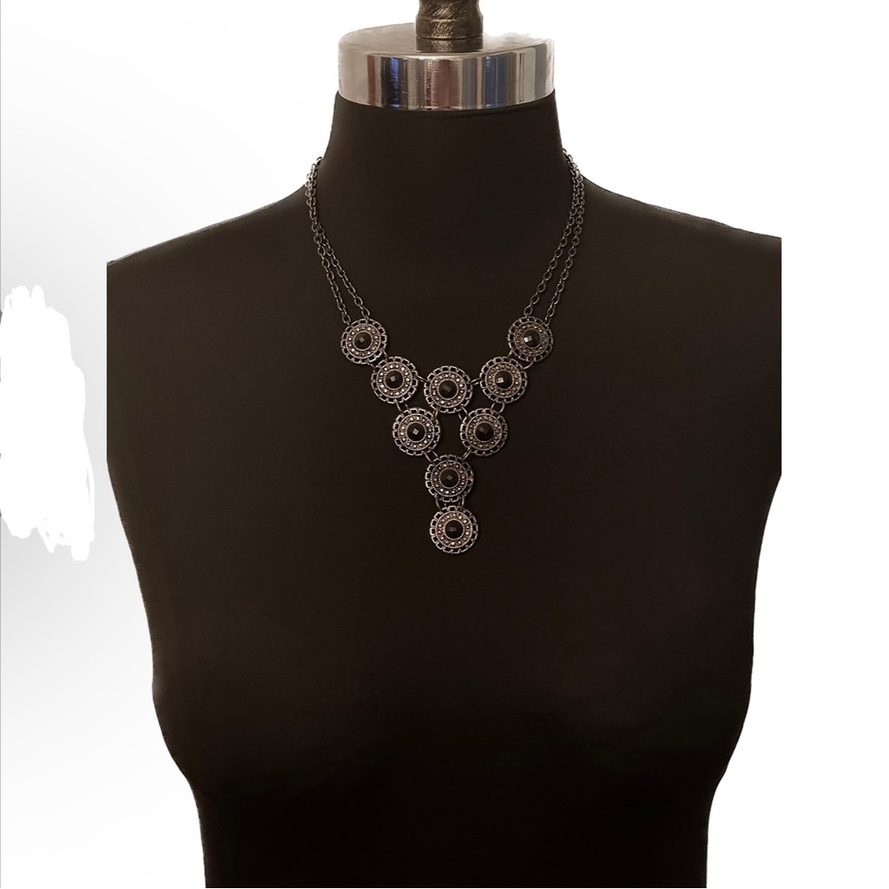 Premier Designs statement bib necklace with 9 circular pendants on dark silver.